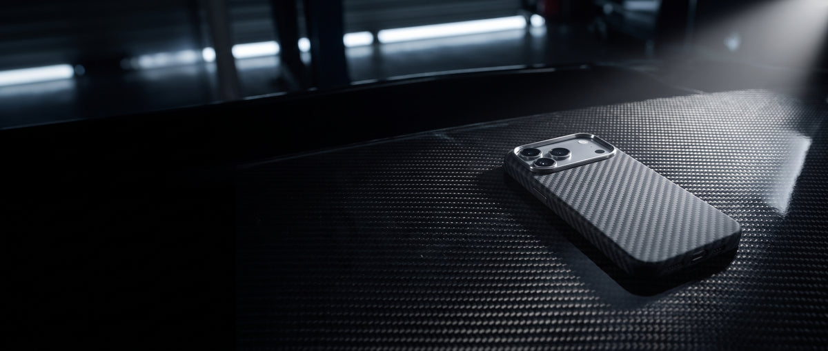 X Caliber carbon case on a carbon-fiber panel in a dark pit garage